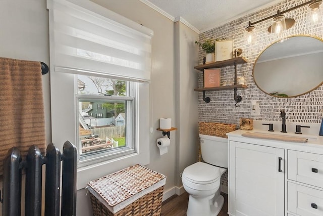 bathroom with crown molding, radiator, wood finished floors, toilet, and tasteful backsplash