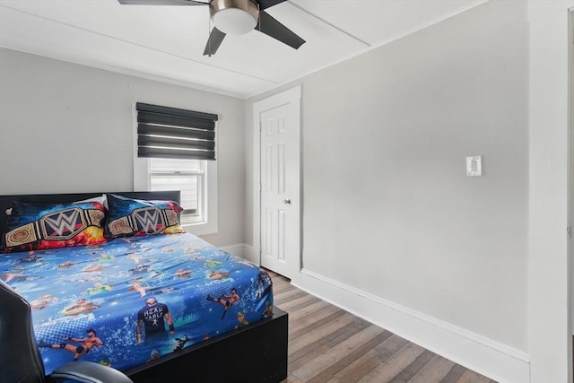 bedroom with baseboards, a ceiling fan, and wood finished floors