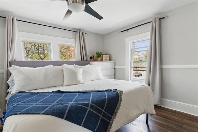 bedroom featuring baseboards, ceiling fan, and wood finished floors