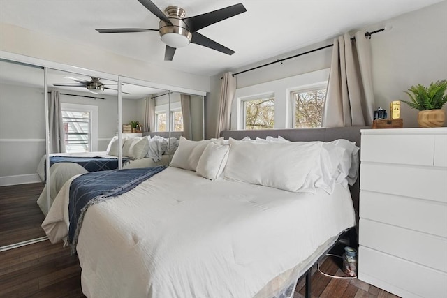 bedroom with baseboards, ceiling fan, and wood finished floors