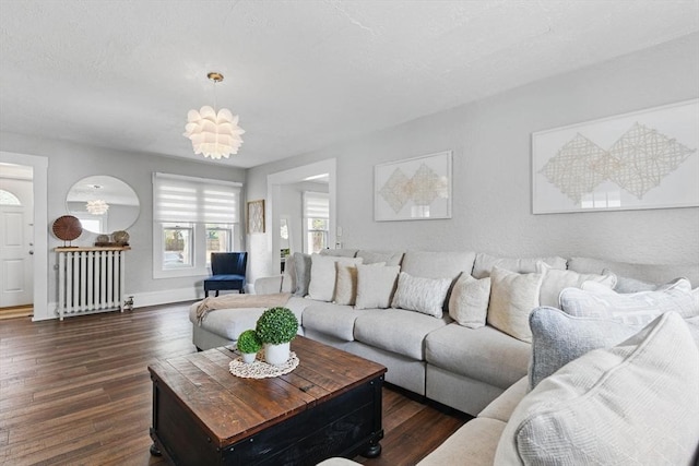 living room with baseboards, radiator heating unit, and dark wood-type flooring