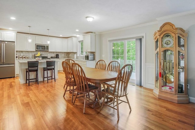 11 Bigelow Dr Unit 11, Berlin, MA 01503 - dining area with light wood finished floors, crown molding, and a wainscoted wall