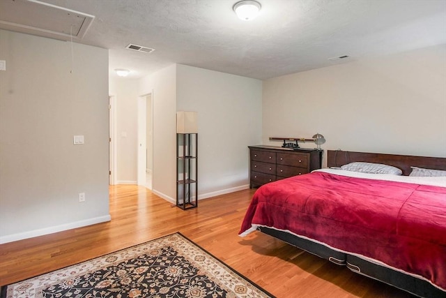 11 Bigelow Dr Unit 11, Berlin, MA 01503 - bedroom featuring attic access, light wood-style floors, and baseboards