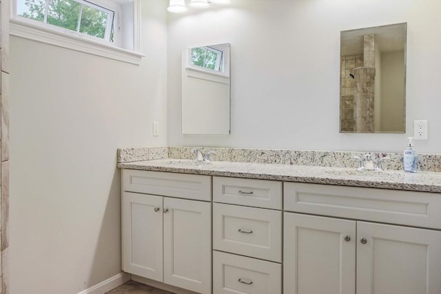 11 Bigelow Dr Unit 11, Berlin, MA 01503 - bathroom with double vanity, a tile shower, and baseboards