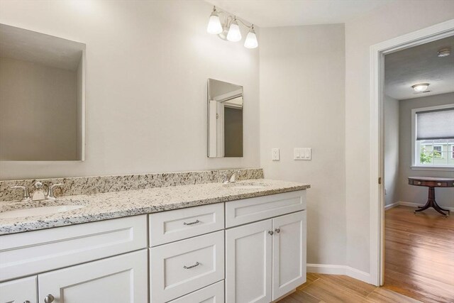 11 Bigelow Dr Unit 11, Berlin, MA 01503 - full bathroom featuring wood finished floors, double vanity, and baseboards