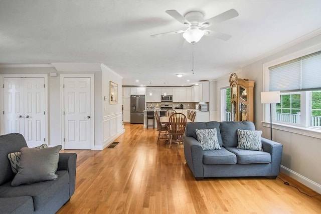 11 Bigelow Dr Unit 11, Berlin, MA 01503 - living room featuring light wood-style flooring, ceiling fan, ornamental molding, and baseboards