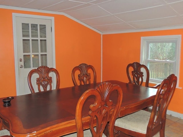 dining room with tile patterned floors and ornamental molding