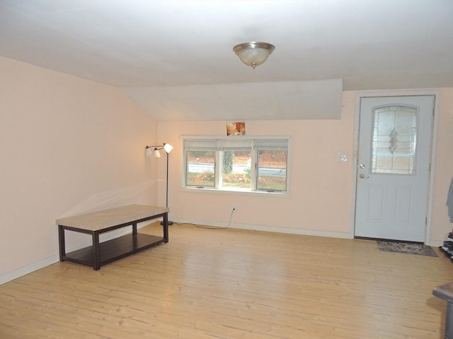 foyer entrance featuring light hardwood / wood-style floors and lofted ceiling