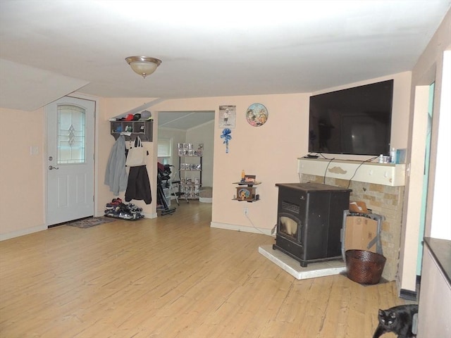 interior space featuring hardwood / wood-style flooring and a wood stove