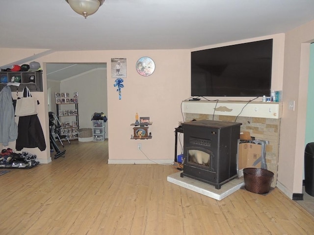 living room with hardwood / wood-style floors and a wood stove