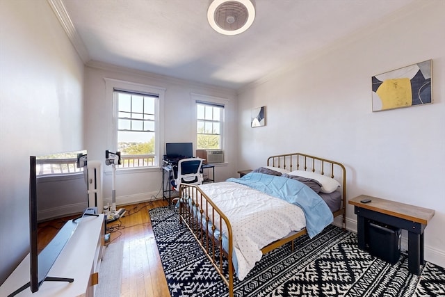 bedroom with wood-type flooring and ornamental molding