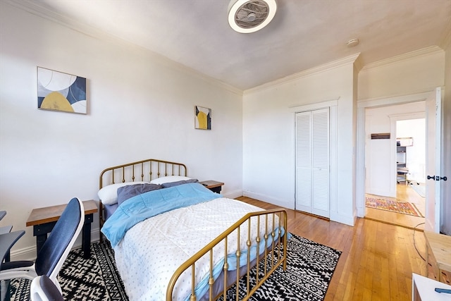 bedroom with wood-type flooring and ornamental molding