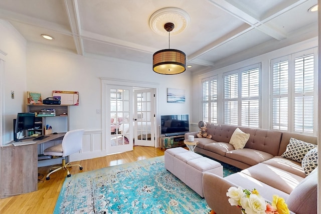 living room with light wood-type flooring, coffered ceiling, french doors, and a wealth of natural light