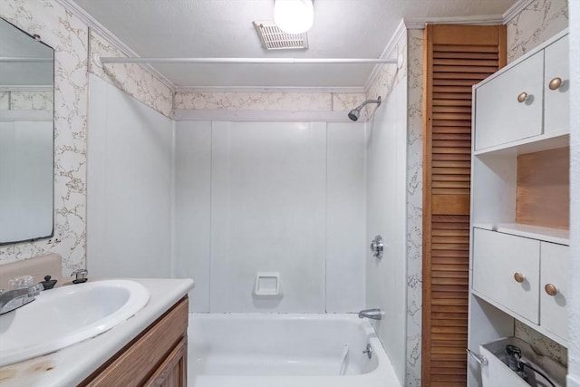 bathroom with bathing tub / shower combination, ornamental molding, and vanity