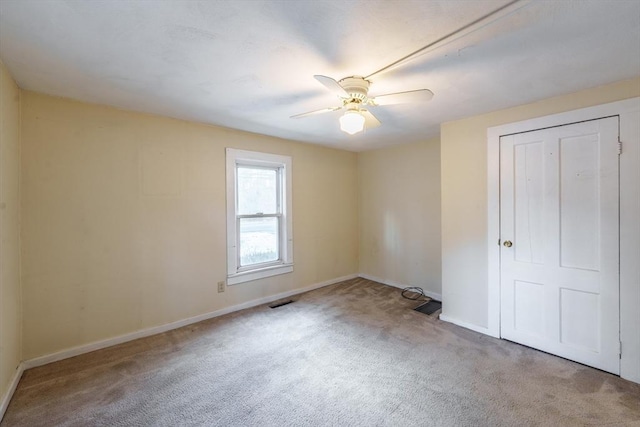 unfurnished bedroom with light colored carpet and ceiling fan