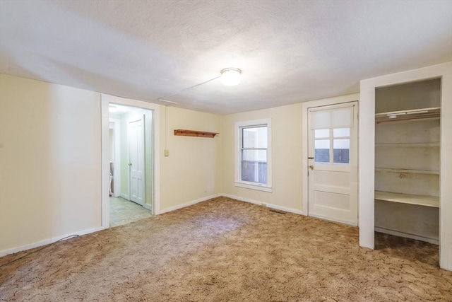 interior space with carpet floors and a textured ceiling