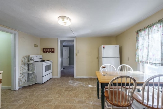 kitchen featuring white appliances and a healthy amount of sunlight