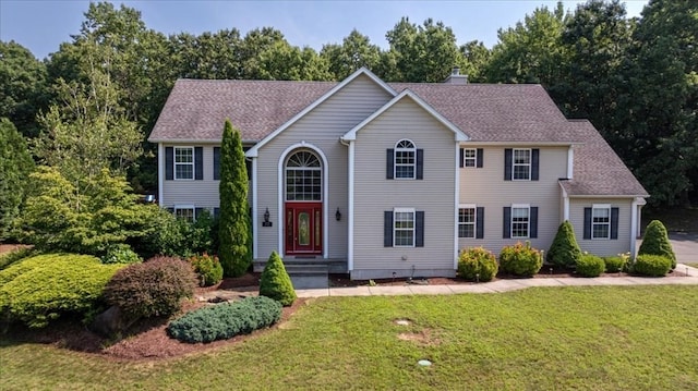 colonial-style house with a front lawn