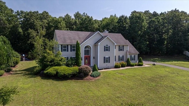 colonial inspired home with a front yard