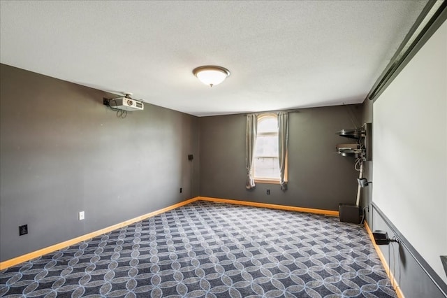 unfurnished room with a textured ceiling