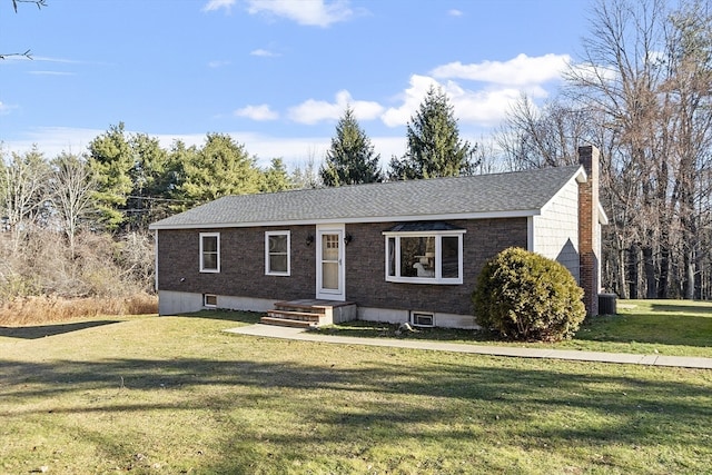 ranch-style house with central air condition unit and a front lawn