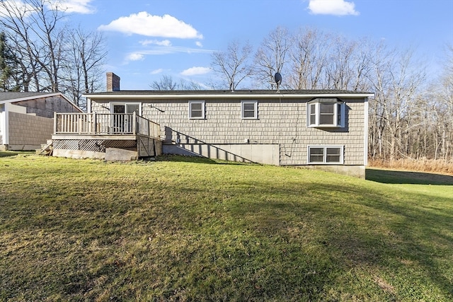 back of house with a lawn and a wooden deck