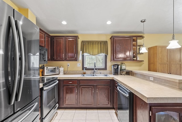 kitchen with hanging light fixtures, light tile patterned flooring, stainless steel appliances, and sink