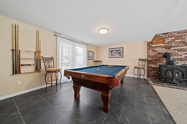 recreation room featuring baseboards, a wood stove, and billiards