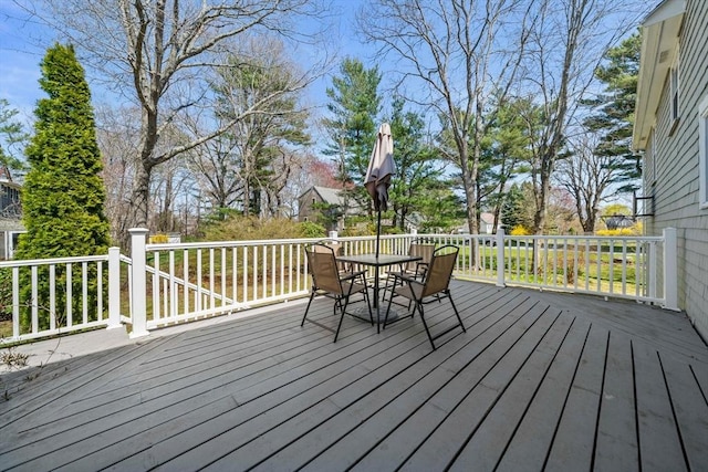 wooden deck featuring outdoor dining area