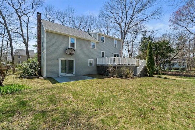 back of house with a patio area, a chimney, a lawn, a deck, and stairs