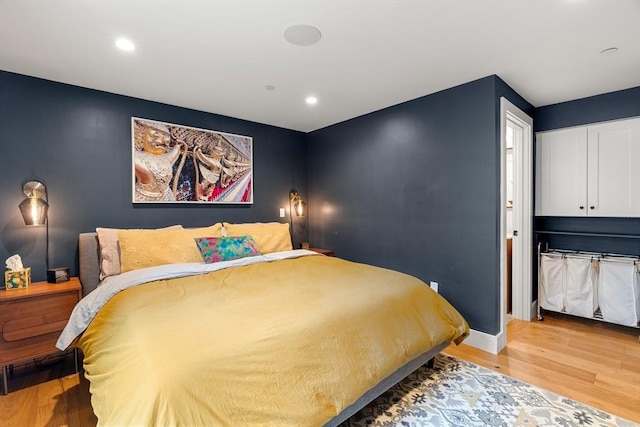 bedroom with baseboards, light wood-style floors, and recessed lighting