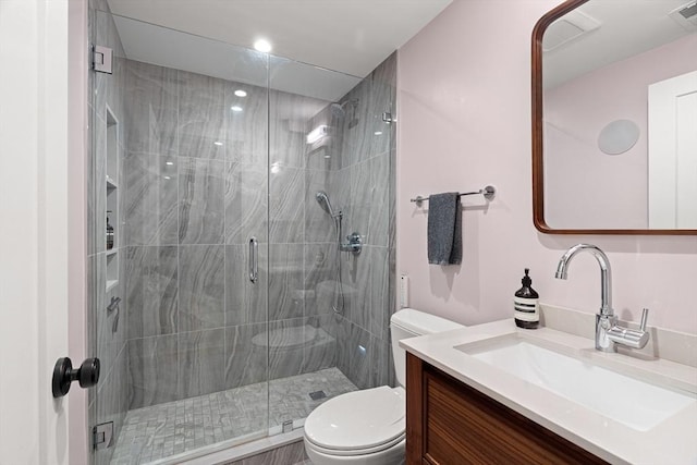 bathroom with recessed lighting, toilet, visible vents, a shower stall, and vanity