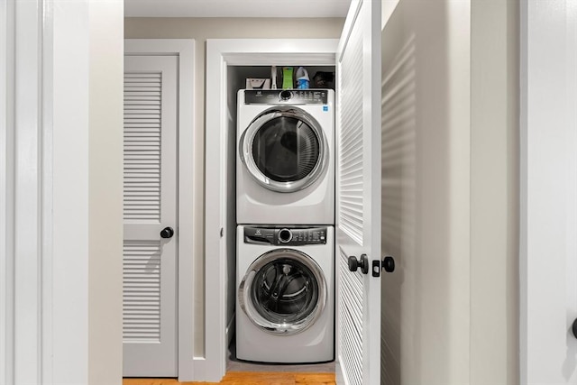 laundry room with stacked washer / dryer and laundry area