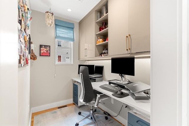office with built in desk, visible vents, baseboards, and recessed lighting