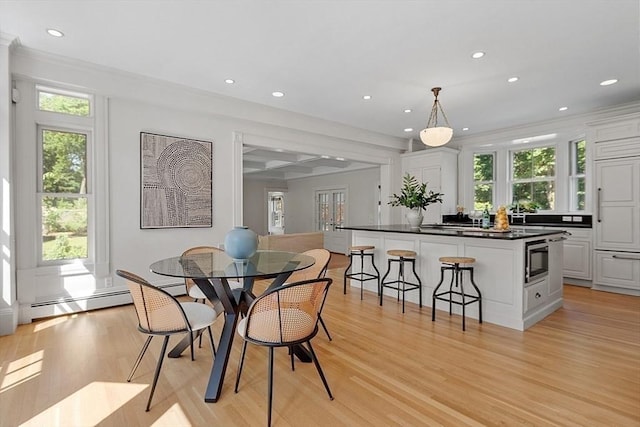 dining space with recessed lighting, light wood-style flooring, plenty of natural light, and a baseboard radiator