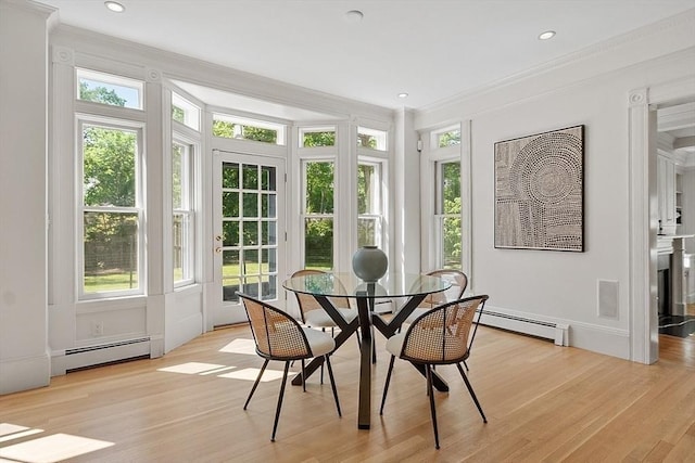 sunroom with a baseboard radiator, ornamental molding, wood finished floors, plenty of natural light, and recessed lighting
