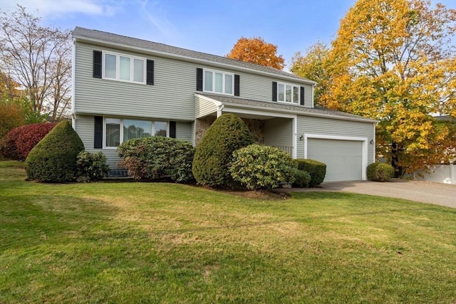 view of front of house with a garage, concrete driveway, and a front yard