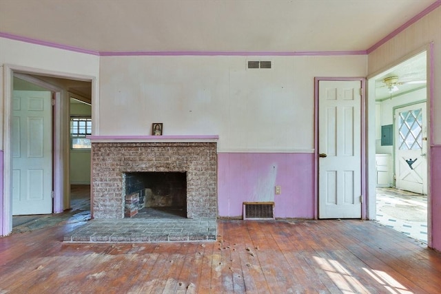 91 Baxter Rd, Barnstable, MA 02601 - unfurnished living room featuring hardwood / wood-style flooring, electric panel, ornamental molding, and a brick fireplace