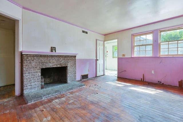 91 Baxter Rd, Barnstable, MA 02601 - unfurnished living room featuring hardwood / wood-style floors, crown molding, and a brick fireplace