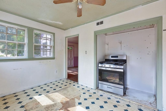 91 Baxter Rd, Barnstable, MA 02601 - kitchen with stainless steel range with gas stovetop, light flooring, ceiling fan, and a textured ceiling