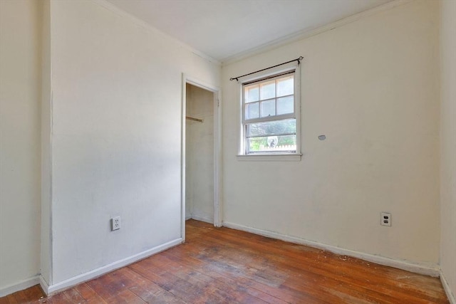 91 Baxter Rd, Barnstable, MA 02601 - unfurnished bedroom with ornamental molding, hardwood / wood-style floors, baseboards, and a closet