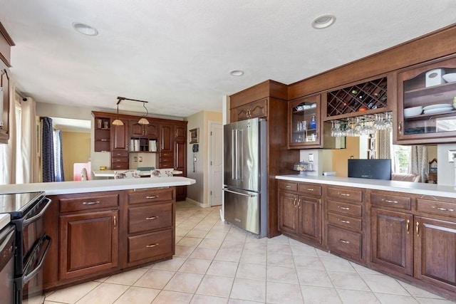 kitchen featuring light countertops, electric range, and high end fridge