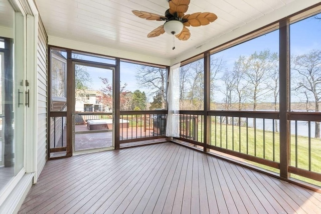 unfurnished sunroom featuring ceiling fan