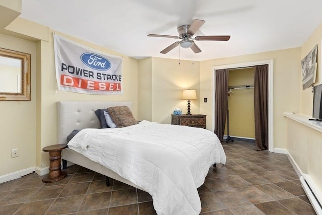 bedroom featuring a closet, baseboards, ceiling fan, and a baseboard radiator