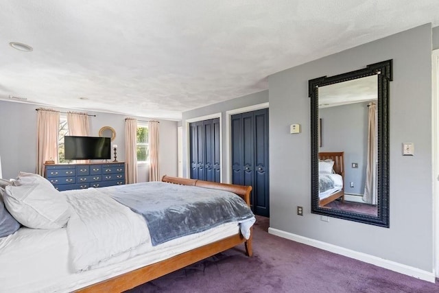 carpeted bedroom with baseboards and multiple closets