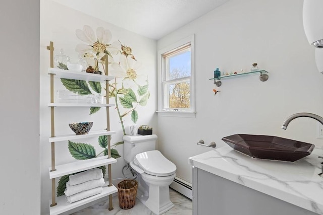 half bathroom featuring vanity, a baseboard heating unit, and toilet