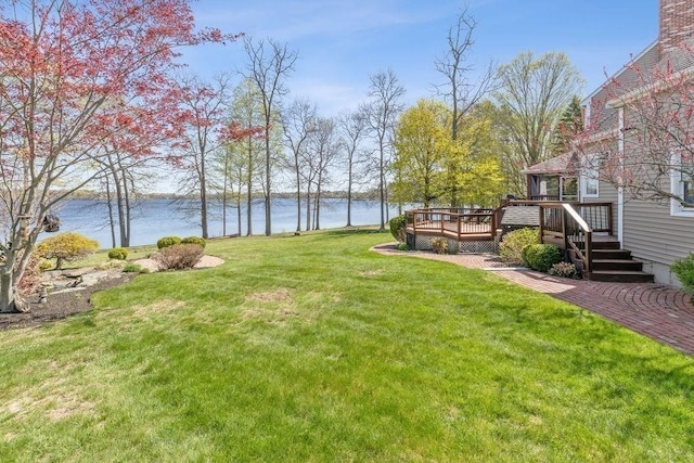 view of yard featuring a deck with water view