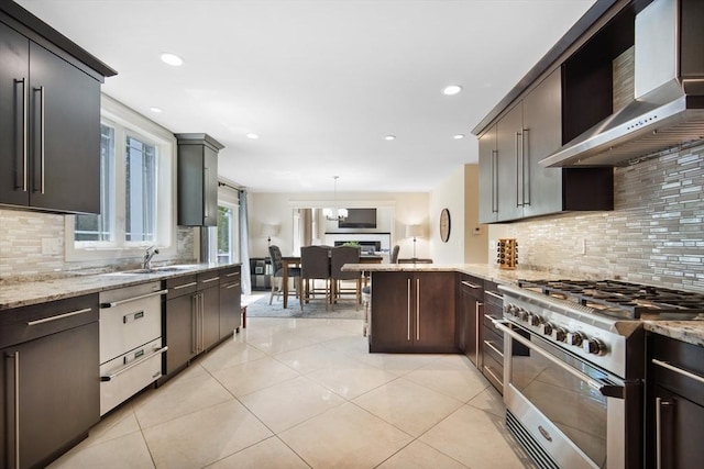 2 Nikkis Way, Hadley, MA 01035 - kitchen featuring wall chimney range hood, high end stainless steel range, decorative backsplash, light tile patterned flooring, and light stone countertops