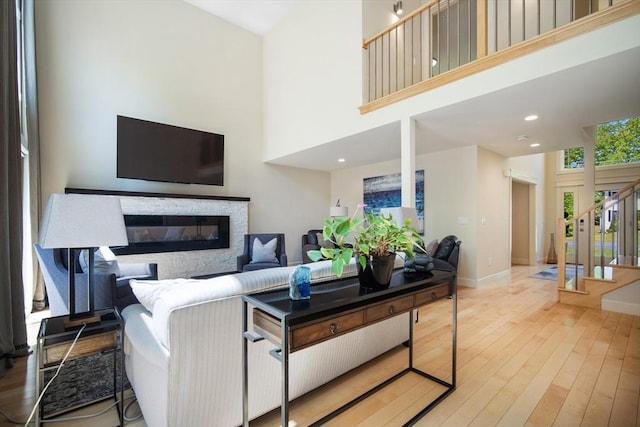 2 Nikkis Way, Hadley, MA 01035 - living area featuring a towering ceiling, wood finished floors, stairway, a stone fireplace, and recessed lighting