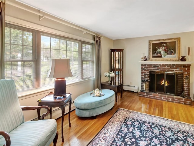 442 Purchase St, Easton, MA 02375 - sitting room featuring a baseboard radiator, wood finished floors, and a fireplace